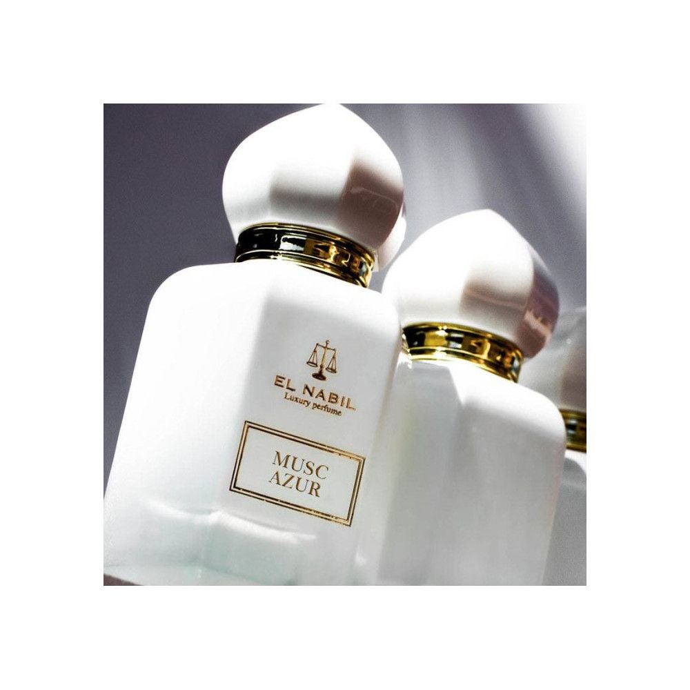 Weißer Flakon mit goldener Verzierung und Deckel. Aufschrift: El Nabil, Musc Azur. Spiegelung.