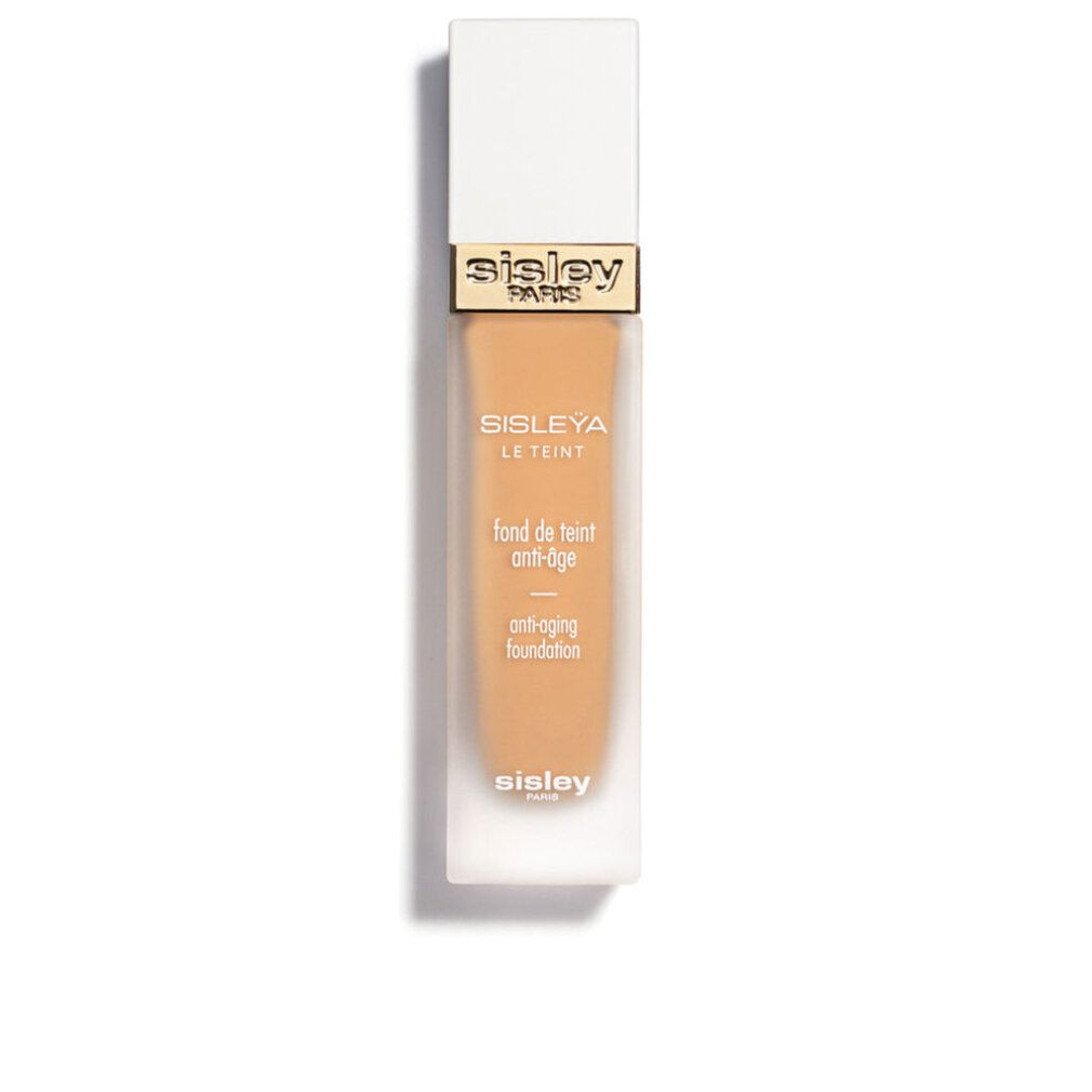 Sisley Sisleya Le Teint Foundation. Rechteckige Flasche mit weißem Deckel und goldenen Akzenten. Produkttext sichtbar.