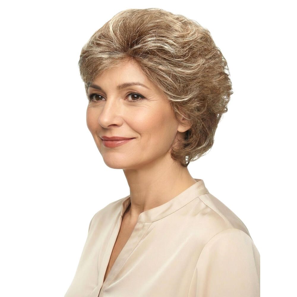 Perücke MONACO. Blond-meliertes Kunsthaar. Seitenansicht einer Frau. Sie trägt eine beige Bluse. Der Hintergrund ist weiß.