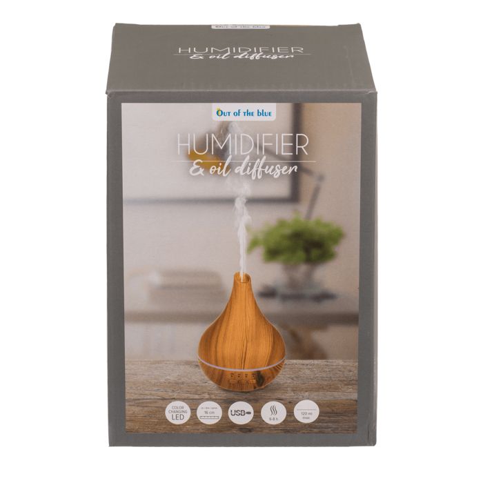 Produktverpackung mit Luftbefeuchter/Öl-Diffusor. Aufschrift: "Out of the blue". Holzoptik-Design, Dampf sichtbar.