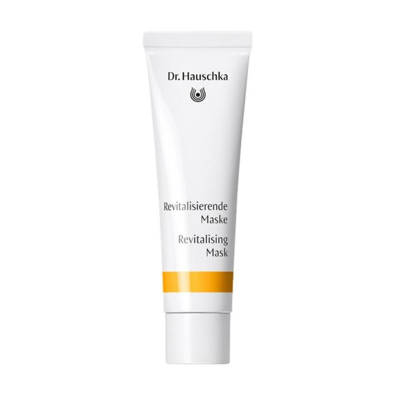 Weiße Tube mit gelbem Streifen. Beschriftung: Dr. Hauschka, Revitalisierende Maske, Revitalising Mask.
