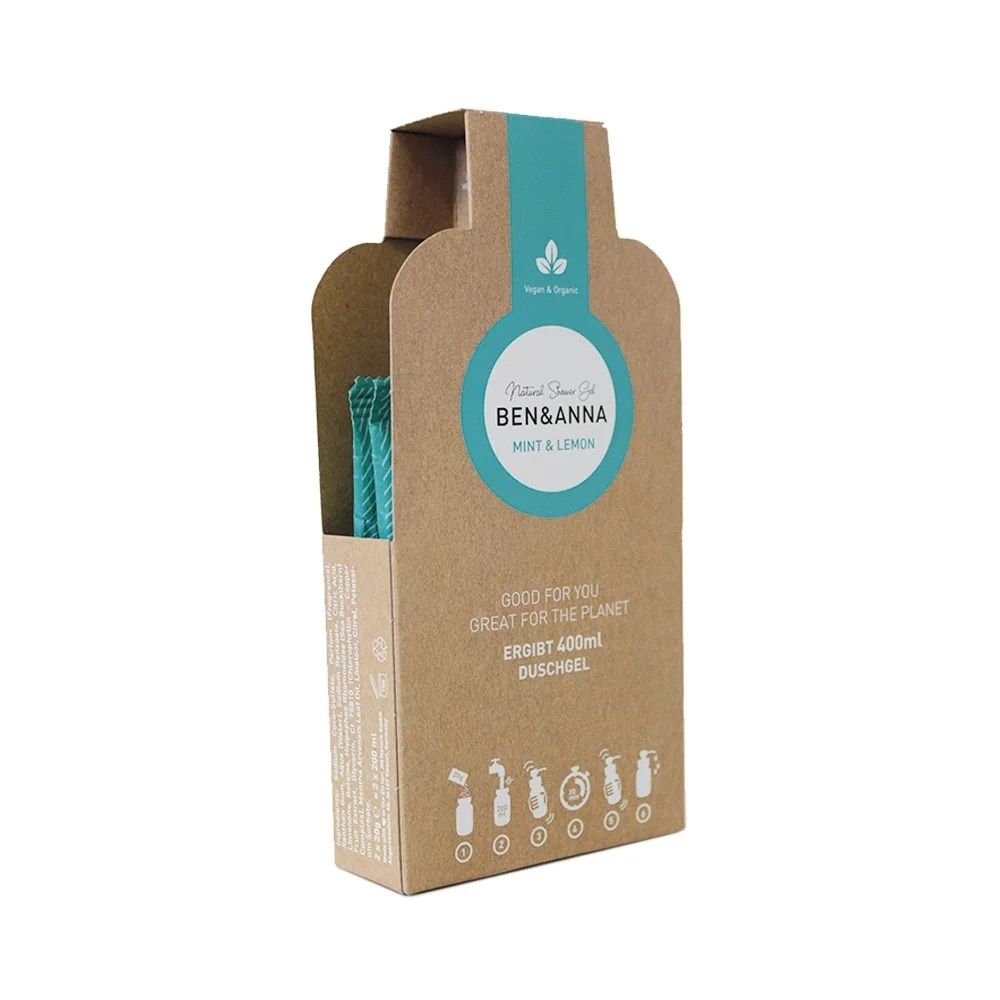 Braune Verpackung mit blauem Etikett. Text: Ben & Anna, Mint & Lemon, Duschgel. Enthält eine blaue Bürste.