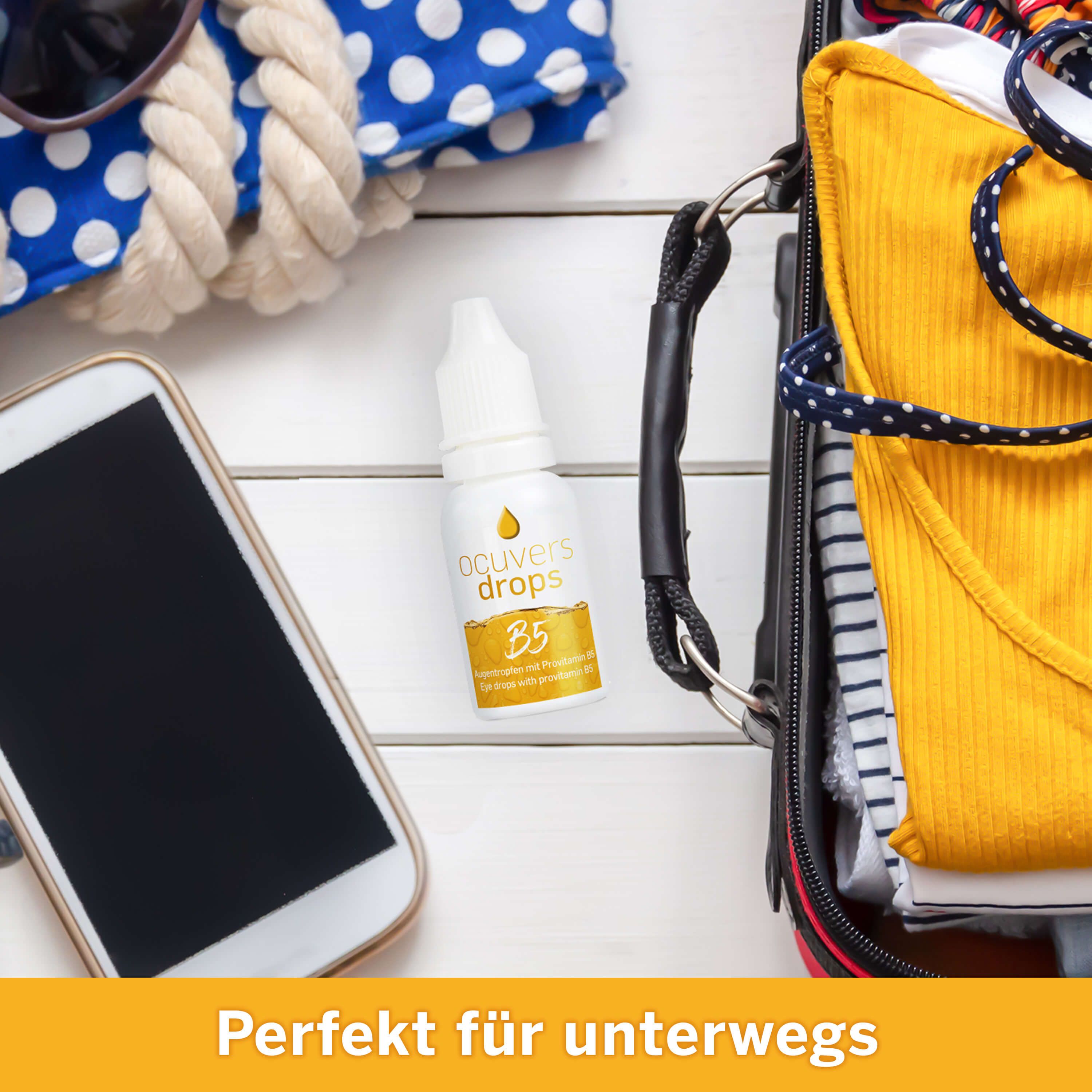 Ocuvers drops B5-Flasche auf weißem Holz, neben Sonnenbrille, Smartphone, Tasche. Text: Perfekt für unterwegs.