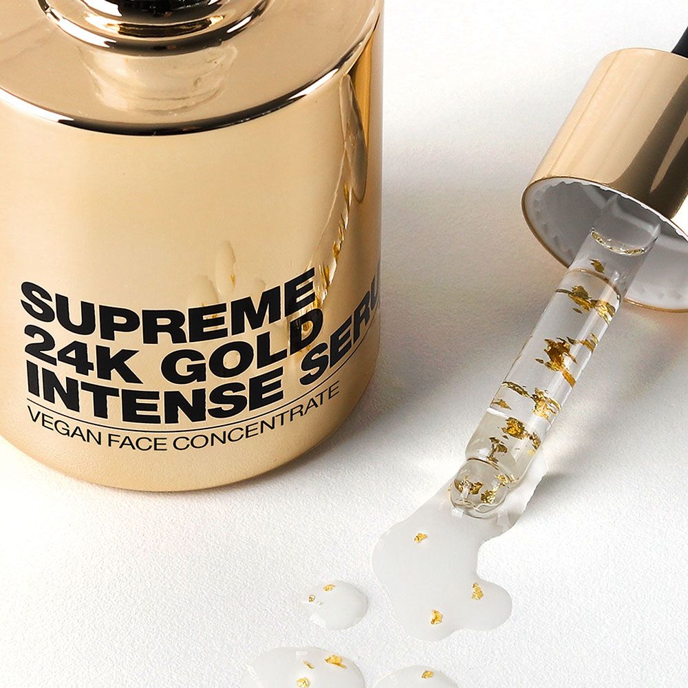 Goldfarbene Serumflasche mit Tropfer. Tropfen Serum mit Goldflocken. Aufschrift: Supreme 24K Gold Intense Serum. Vegan Face Concentrate.
