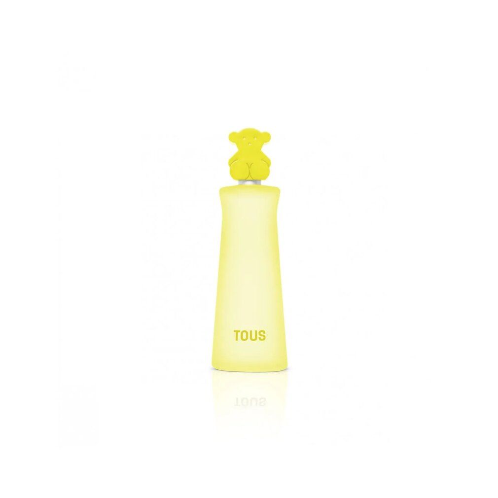 Gelbes Parfumflakon mit Bärenkopf-Verschluss. Aufschrift: TOUS. Flakon reflektiert auf weißem Untergrund.