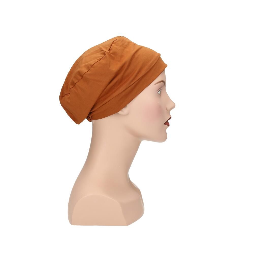 Ockerfarbener Turban auf einer Schaufensterpuppe. Seitenansicht. Stoff mit Falten. Für Kopfbedeckung.