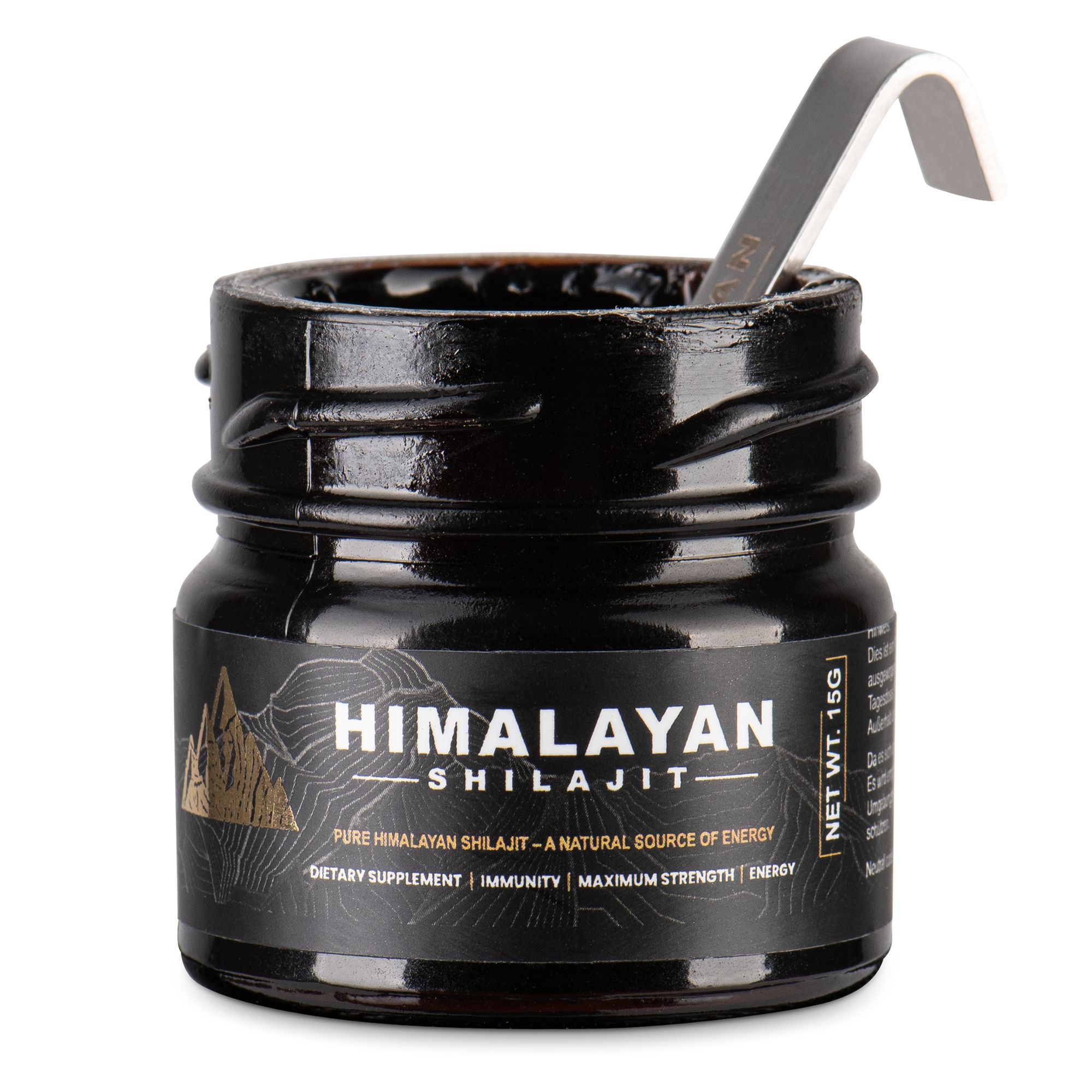 Glasbehälter mit schwarzem Shilajit. Löffel im Behälter. Aufschrift: Himalayan Shilajit.