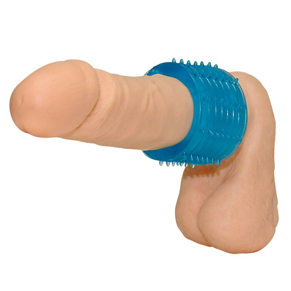 Blaues, zylindrisches Produkt mit Noppen, um einen Penis gelegt. Oberfläche mit erhabenen, kegelförmigen Strukturen.