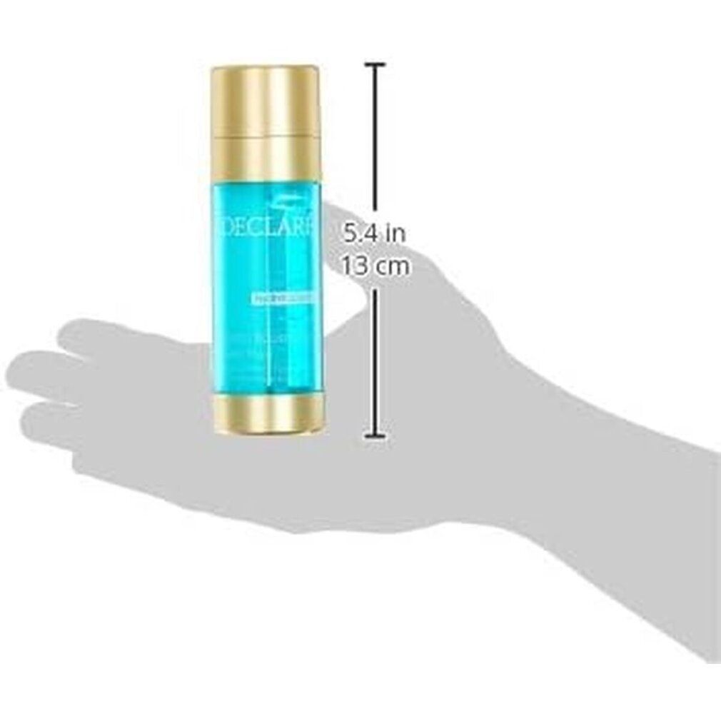 Produkt umgeben von Wasserspritzern. Zylinderförmige Flasche mit blauem Inhalt, goldfarbenen Deckel und Boden. DECLARÉ, hydrobalance.