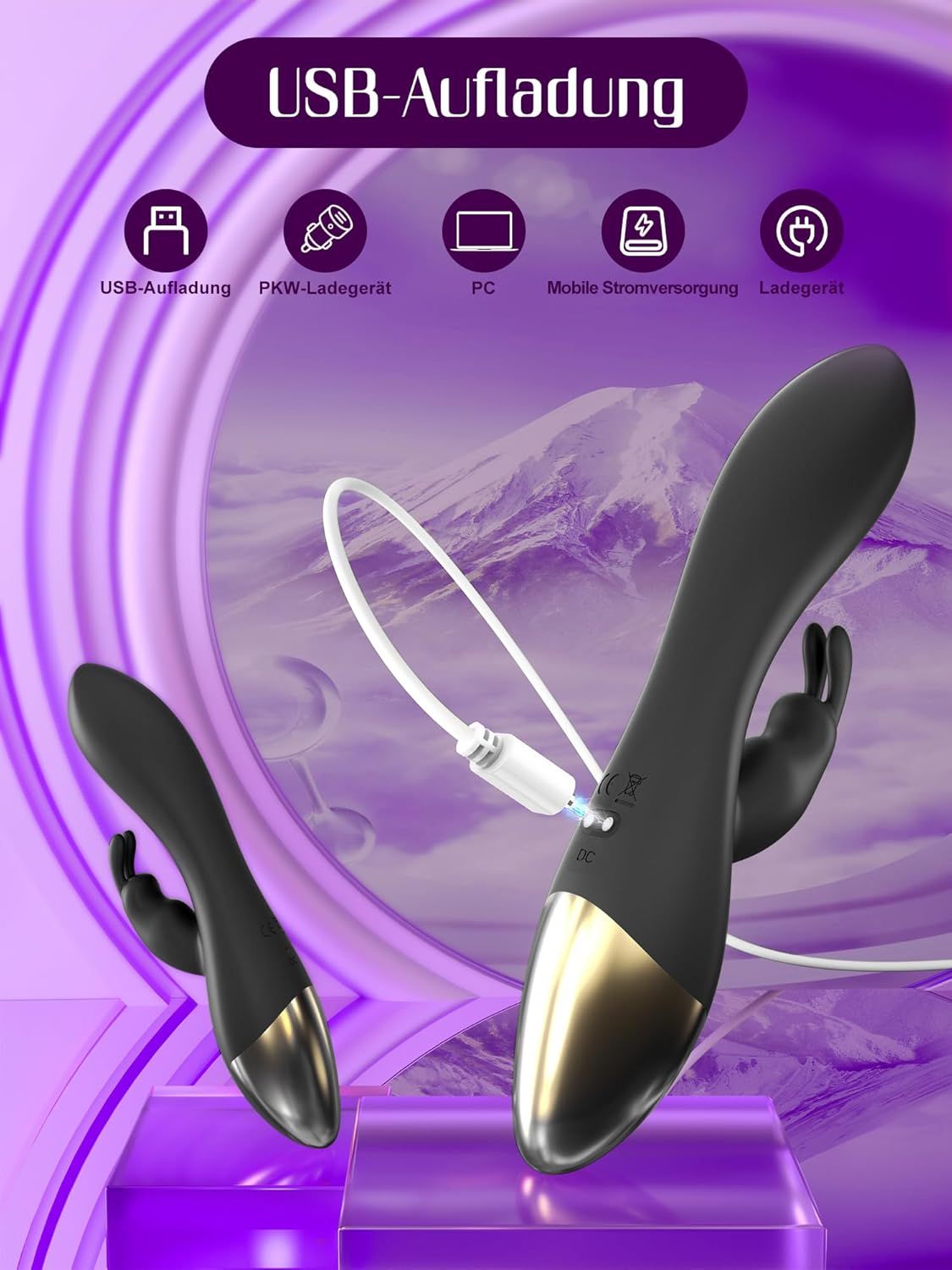 Schwarzer G-Punkt-Vibrator mit goldenem Ende, auf lila Stoff liegend.