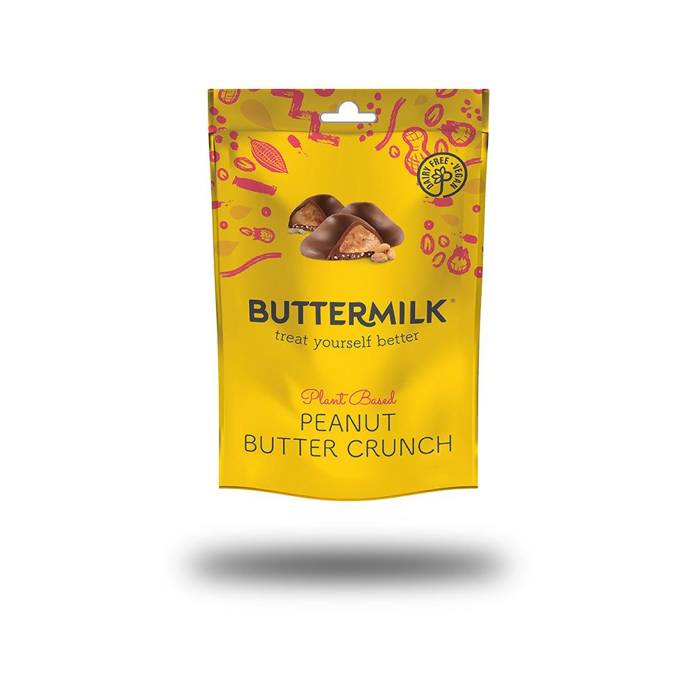Gelbe Verpackung mit Produktbildern. Aufschrift: BUTTERMILK, Erdnussbutter Crunch, glutenfrei. Oben ein Loch zum Aufhängen.