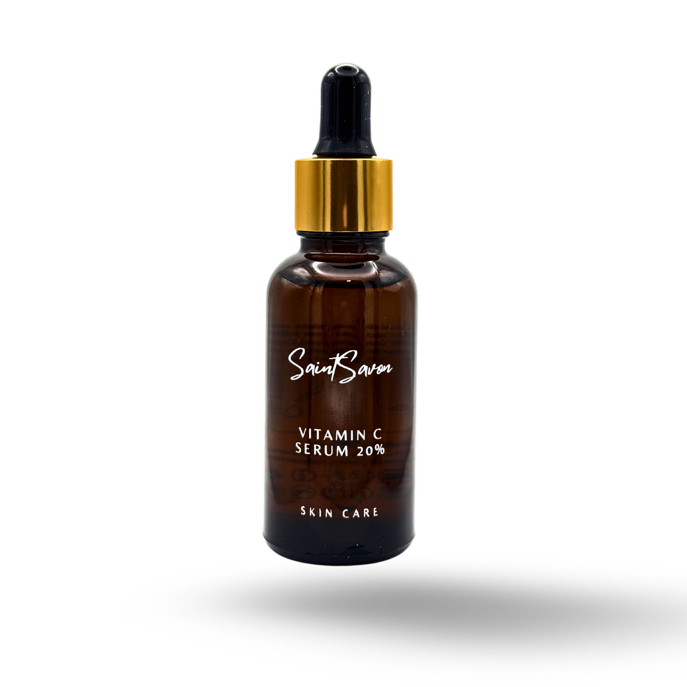Braune Glasflasche mit goldfarbenem Deckel und Pipette. Auf dem Etikett steht "Saint Savon", "Vitamin C Serum 20%" und "Skin Care".
