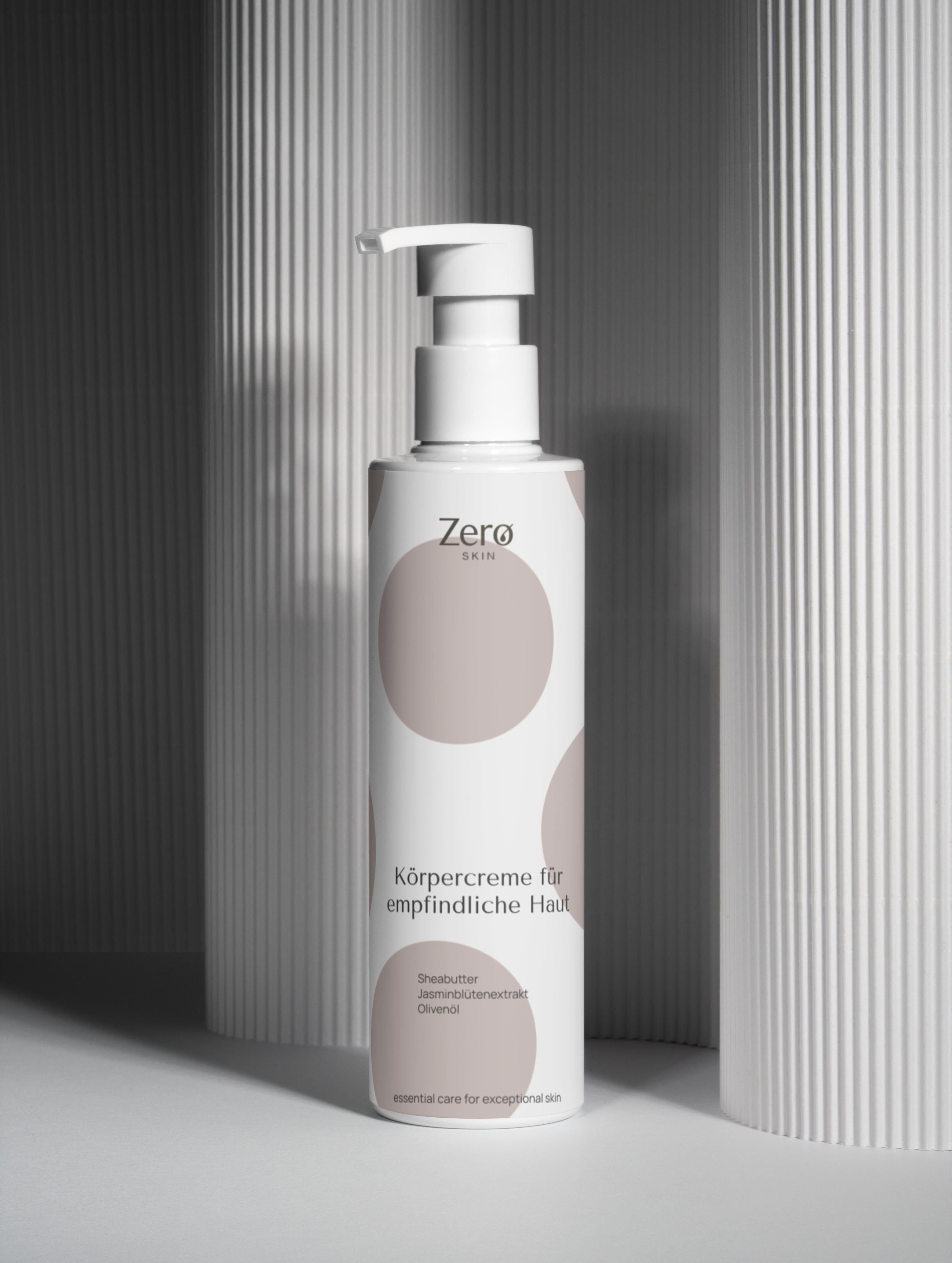 Zero Skin Körpercreme-Flasche mit Pumpverschluss. Weißes Design mit braunen Kreisen. Text: Körpercreme für empfindliche Haut.