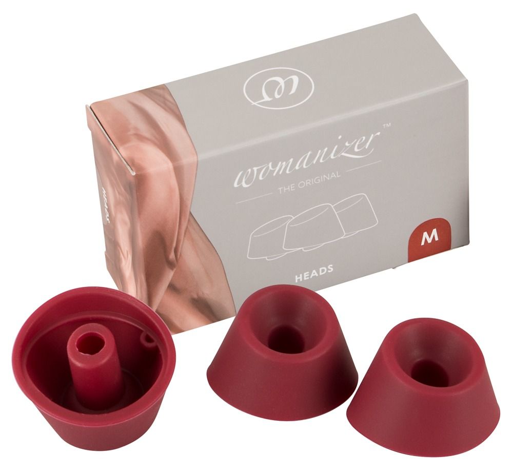 Verpackung und drei Ersatzköpfe. Aufdruck: Womanizer, Heads, M. Rote Ersatzköpfe.