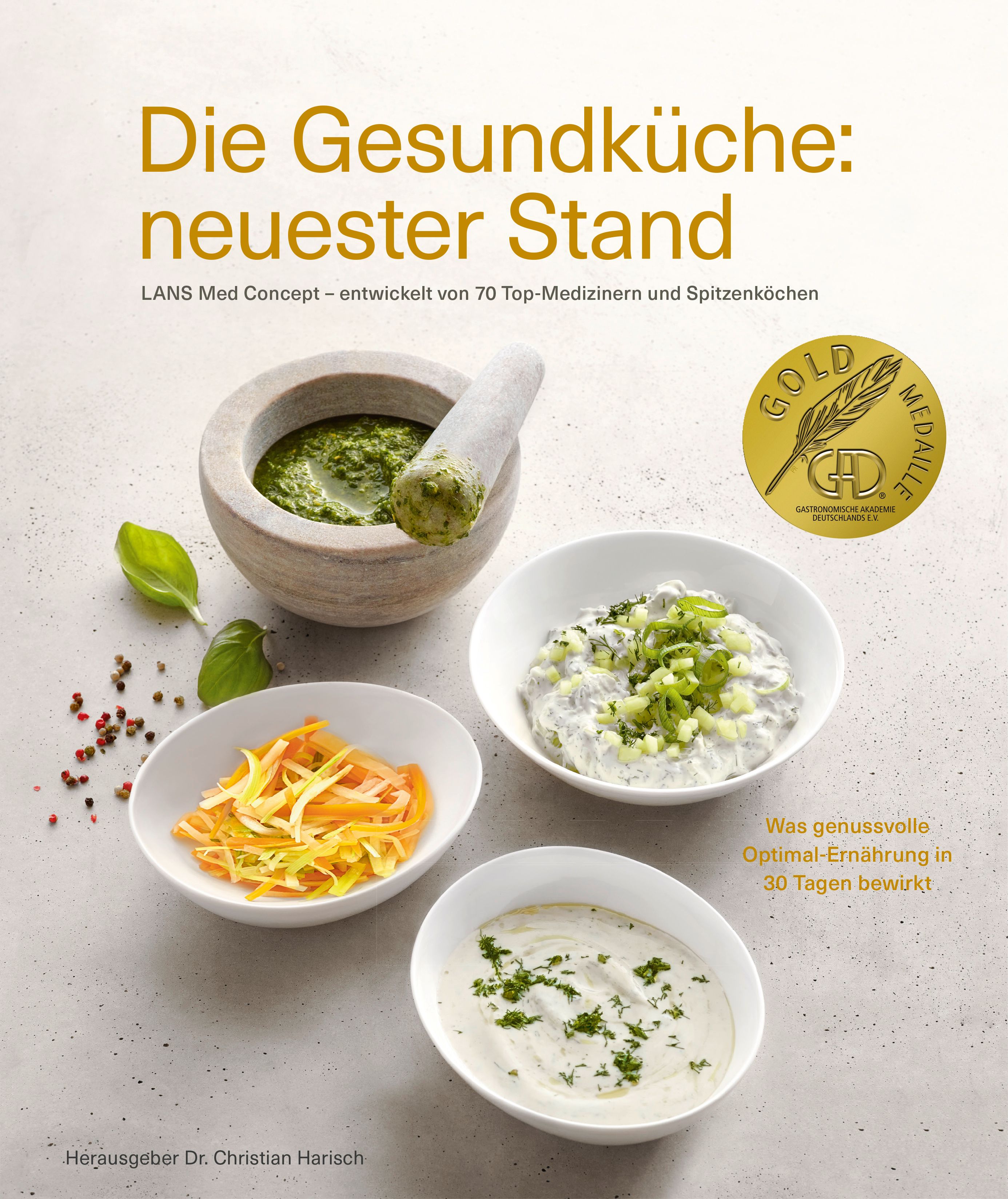Buchcover: "Die Gesundküche: neuester Stand". Goldmedaille. Verschiedene Speisen in Schalen. Herausgeber Dr. Christian Harisch.