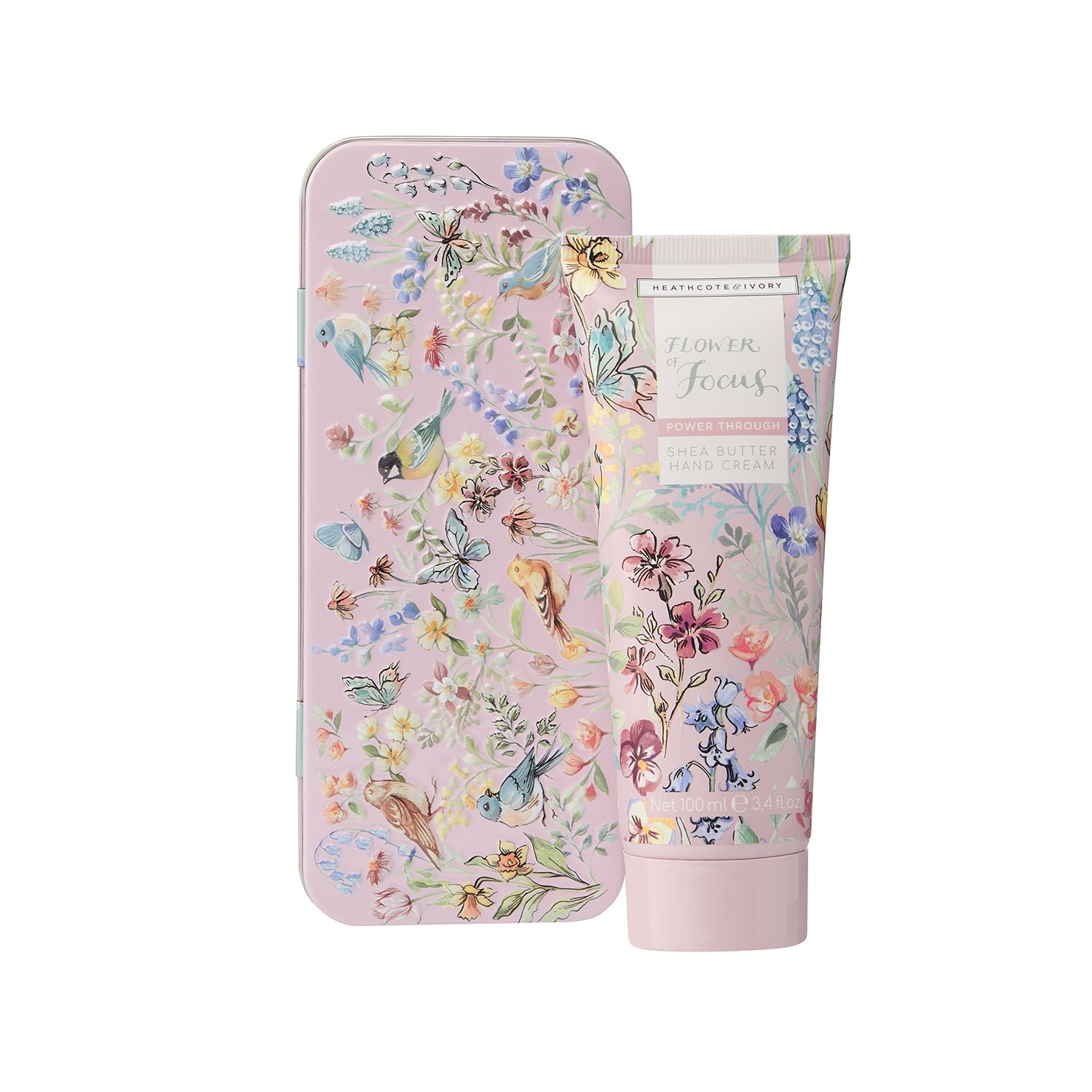 Handcreme und Dose. Dose mit Blumen- und Vogelmuster. Creme-Tube mit Blumenmuster und Text: Flower of Focus, Hand Cream.