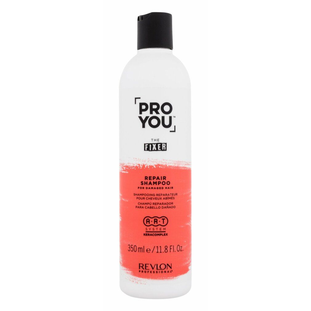 Weiße Flasche mit schwarzem Deckel. Aufschrift: PRO YOU THE FIXER REPAIR SHAMPOO. Revlon-Logo und Text in Rot.