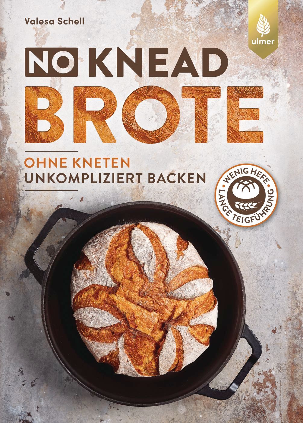 Buchcover mit Brot in einer schwarzen Pfanne. Titel: NO KNEAD BROTE. Autor: Valesa Schell. Logo: Ulmer Verlag.