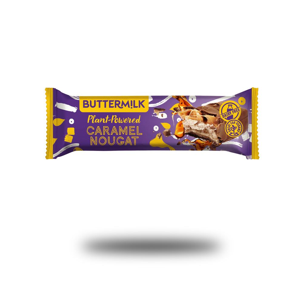 Verpackung Buttermilk Caramel Nougat. Lila-gelbe Verpackung mit Produktbezeichnung und Logo. Teilweise geöffnet, Nougat sichtbar.