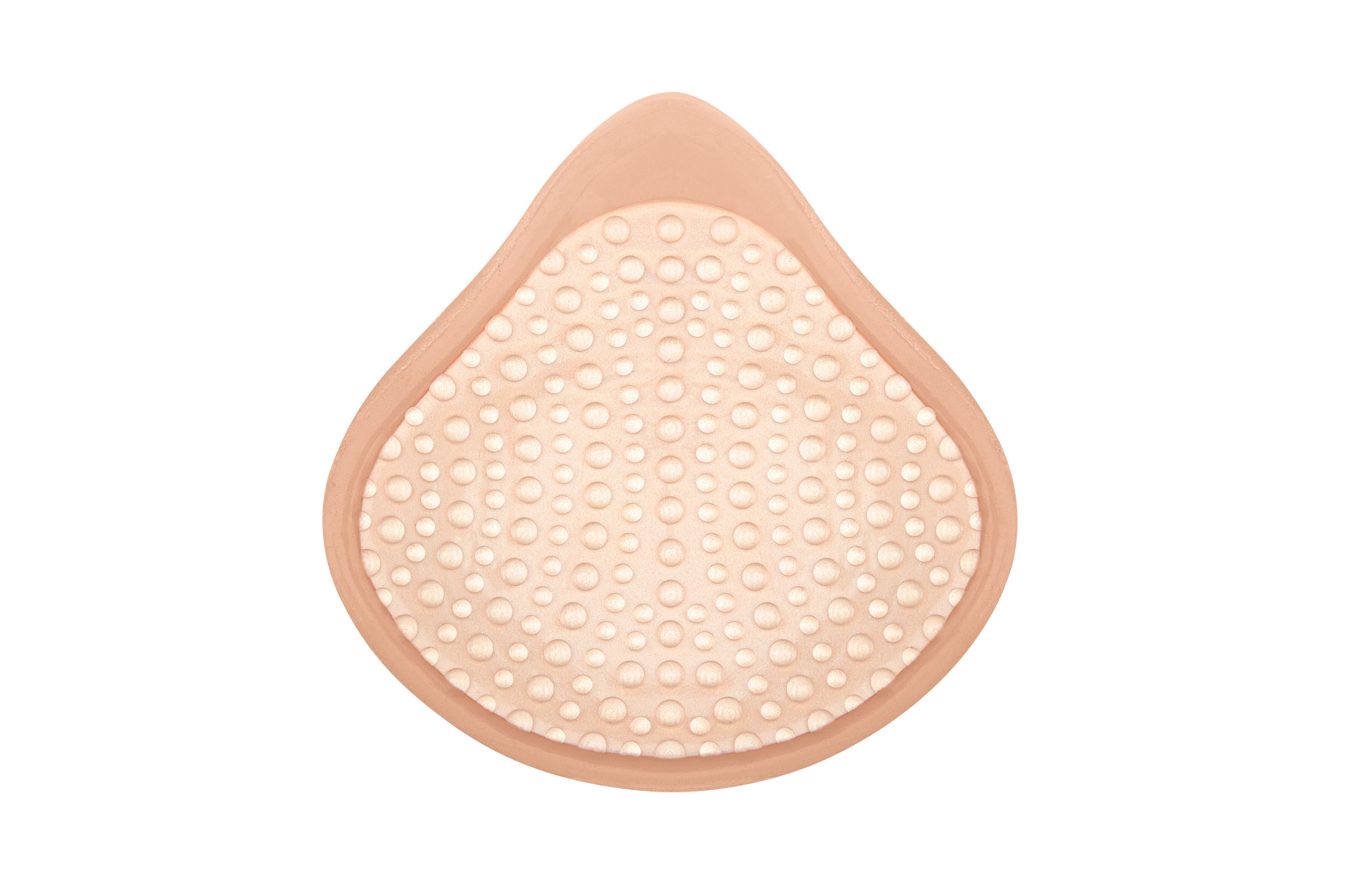 Brustprothese, Rückseite mit Noppenstruktur. Hautfarbenes Material, tropfenförmig.