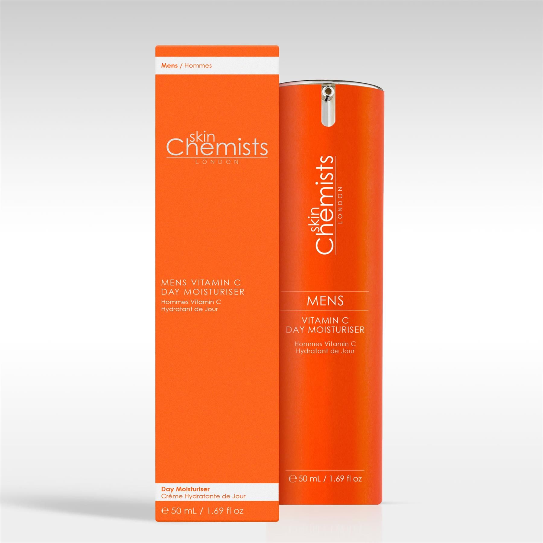 Ein orangefarbener Pumpspender 'MENS VITAMIN C DAY MOISTURISER' neben seiner Verpackung.