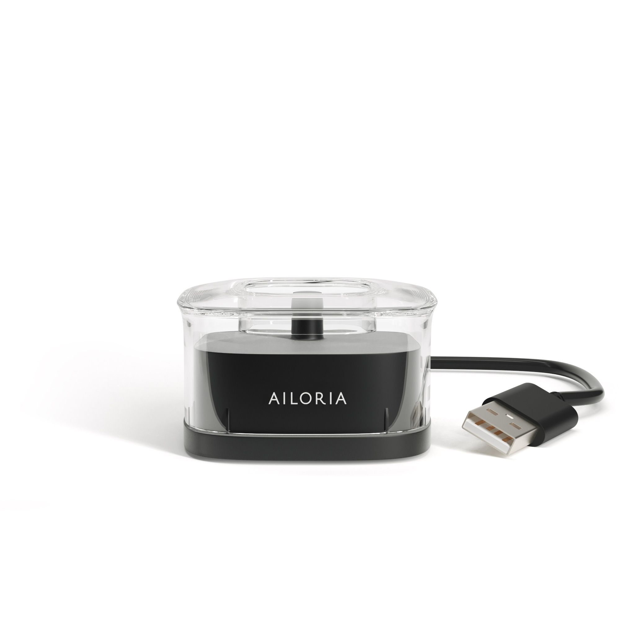 Induktive Ladestation mit USB-Kabel. Schwarzer Sockel mit transparentem Deckel. AILORIA-Schriftzug.