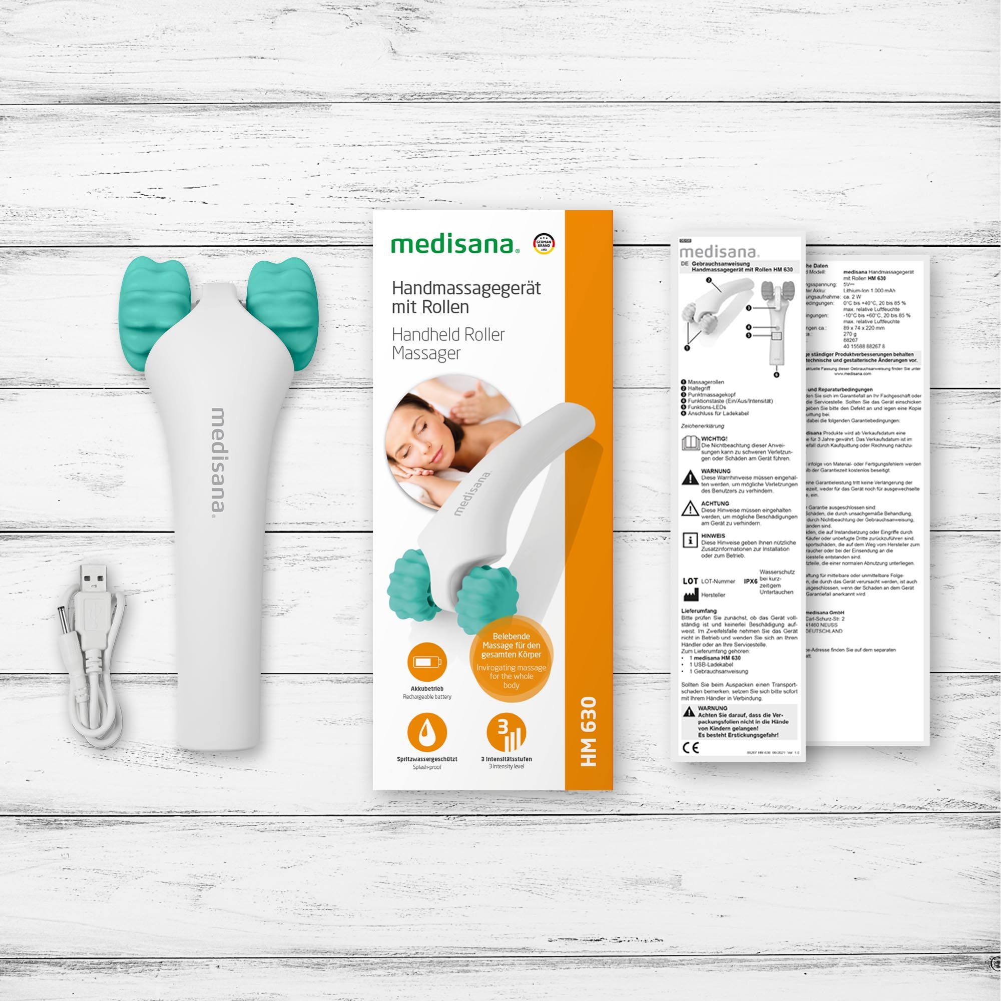 Medisana Handmassagegerät HM 630, weiß mit türkisen Rollen, inklusive Ladekabel und Verpackung.