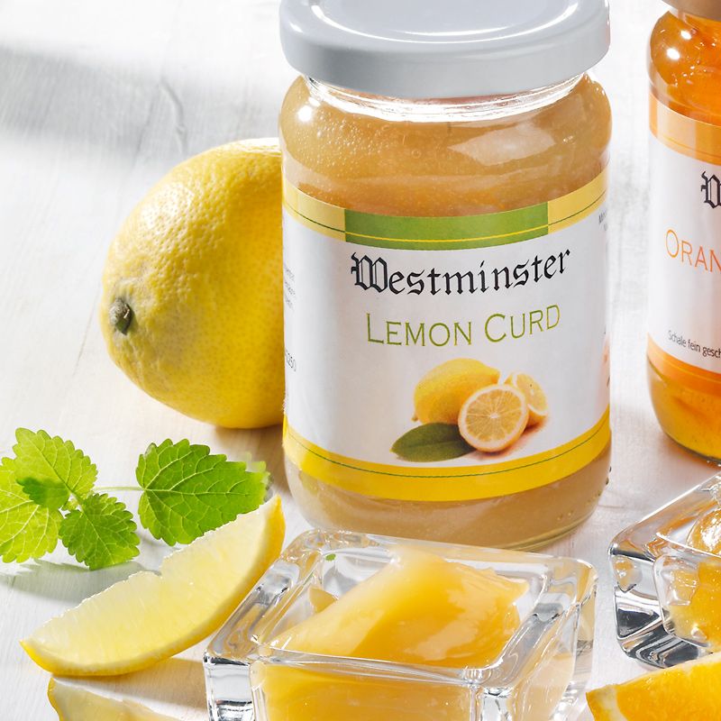 Glas Westminster Lemon Curd. Etikett mit Produktname und Zitrone. Zitrone und Minze daneben. Glas mit Curd.