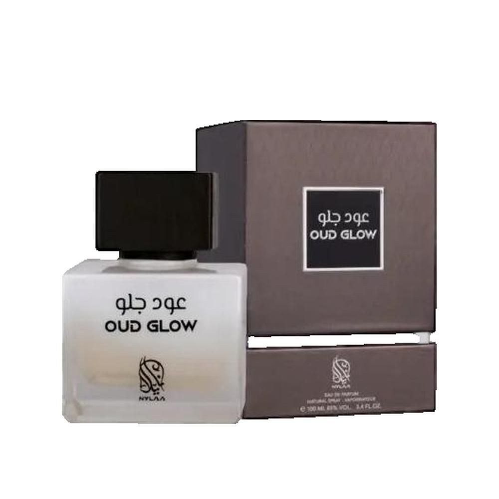 Flakon und Verpackung. Flakon quadratisch, schwarzer Deckel. Aufschrift "OUD GLOW". Verpackung braun.