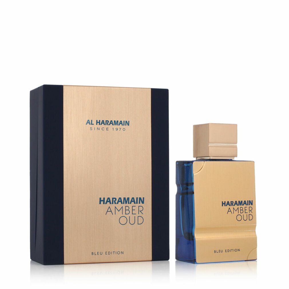 Goldfarbene Parfümflasche mit goldfarbenem Deckel und blauer Basis. Rechteckige Verpackung mit Markenlogo und Produktnamen.