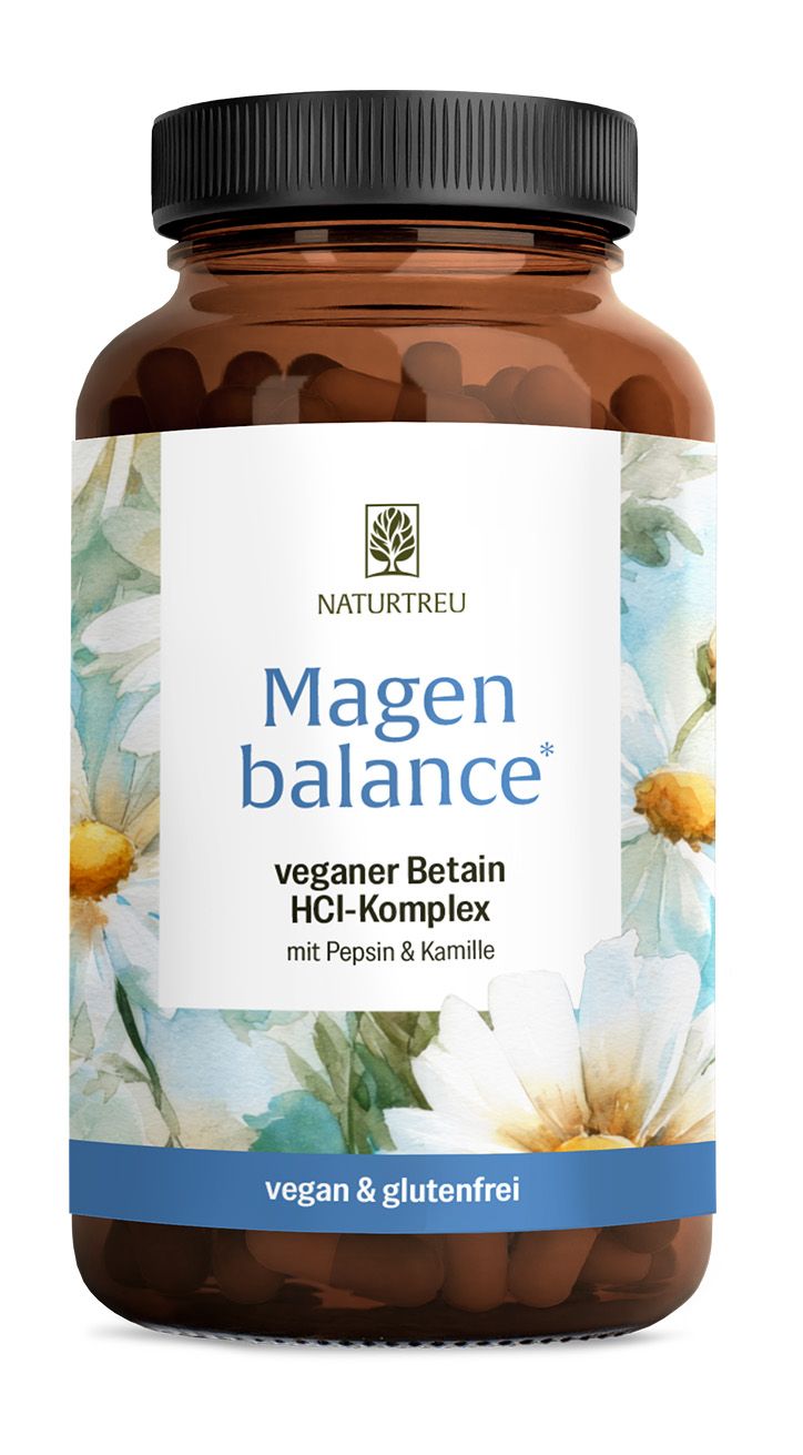 Braune Glasflasche mit weißem Etikett und Blumenmuster, schwarzer Deckel. "Magen balance" Aufschrift.