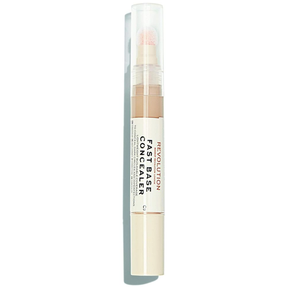 Makeup Revolution Fast Base Concealer. Beige Farbton, Stiftform mit Applikator. Produktname und Marke deutlich sichtbar.