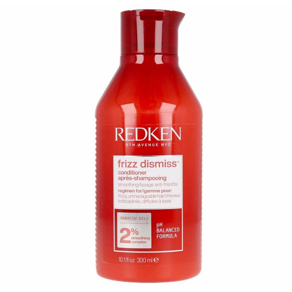 Rote Flasche Redken Frizz Dismiss Conditioner. Text: Après-shampooing, für krauses, widerspenstiges Haar. pH-ausgewogen.