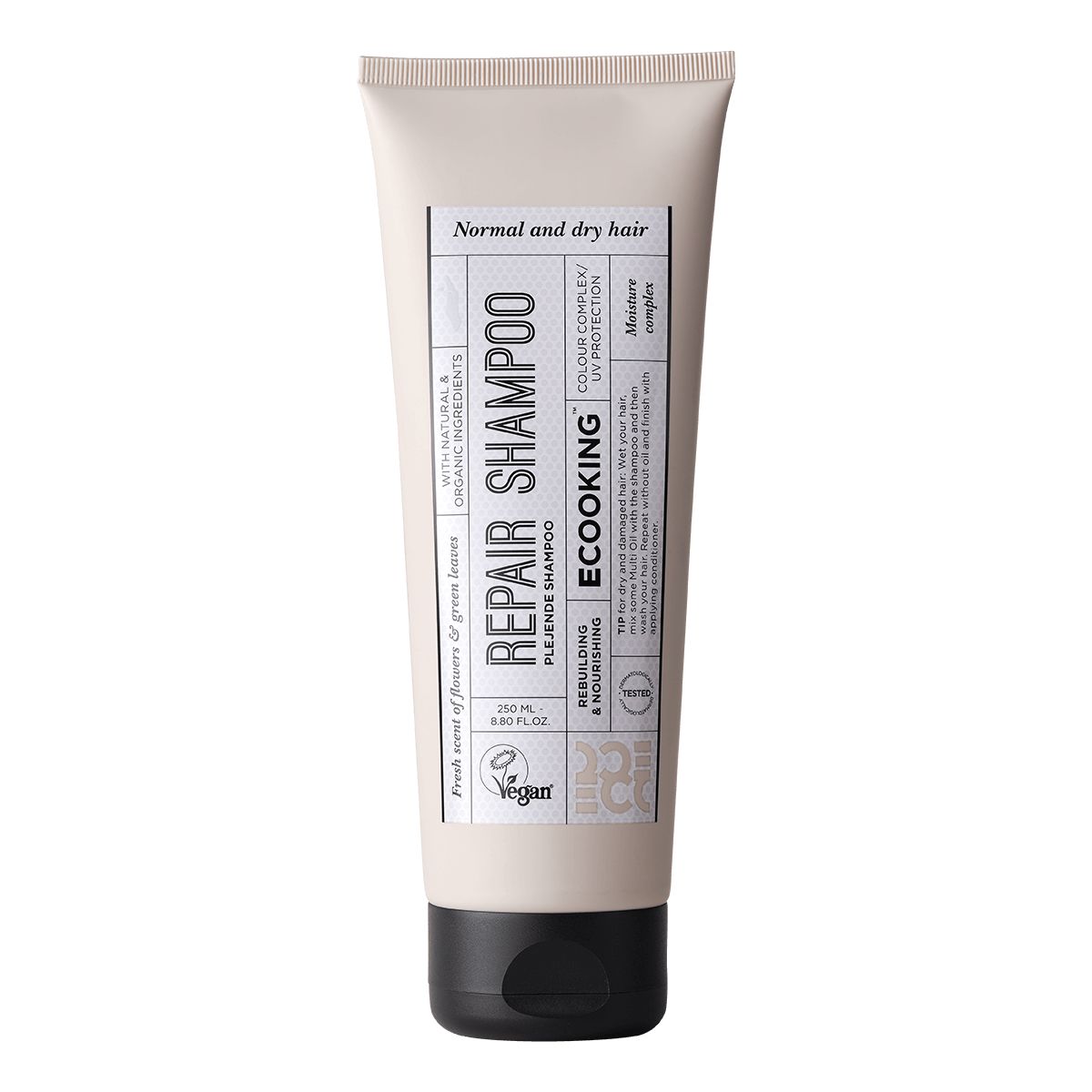 Beige Tube mit schwarzem Deckel. Aufschrift: Repair Shampoo, Ecooking. Für normales und trockenes Haar. Vegan.