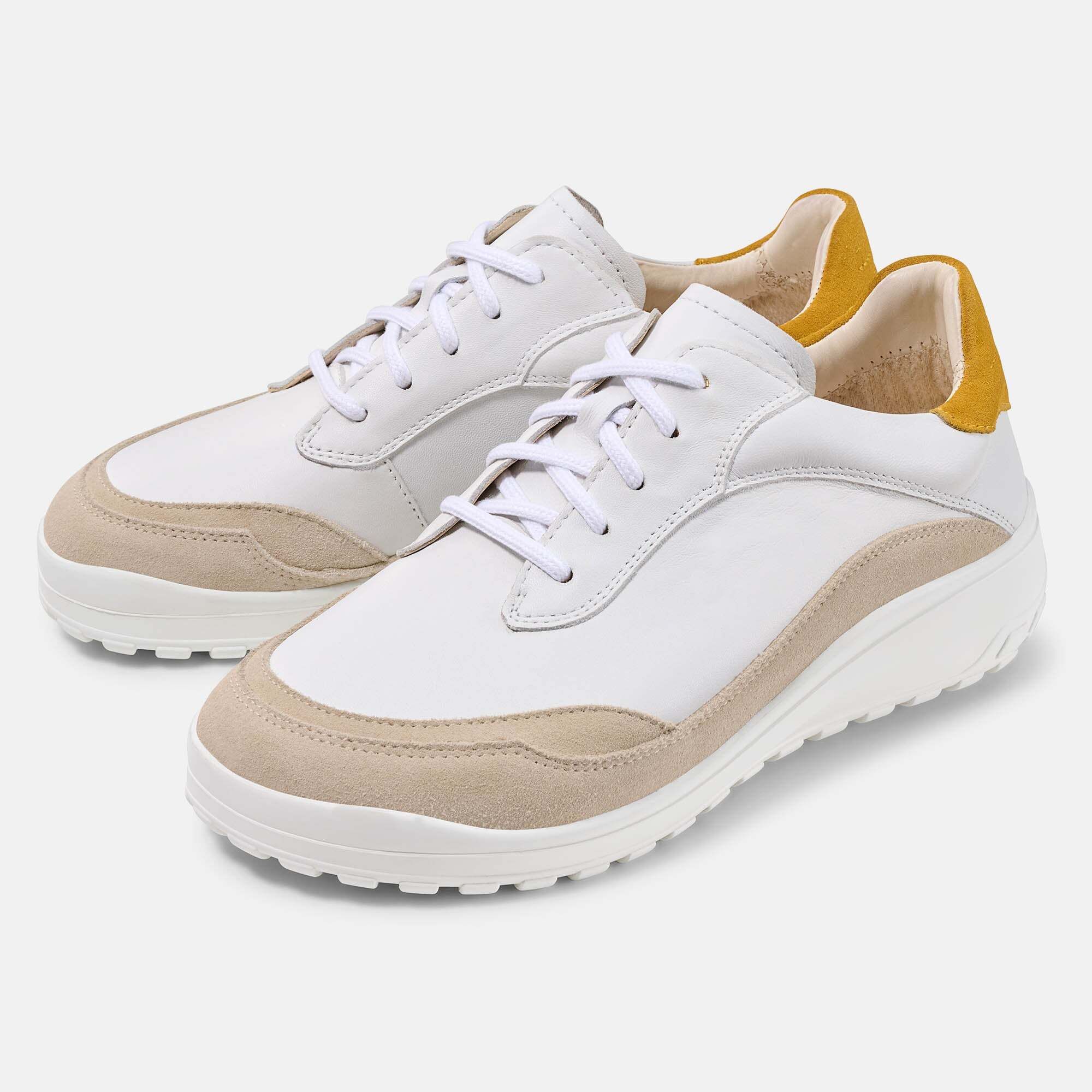 Weiße Damen-Schnürschuhe mit beigen Wildleder-Akzenten und gelben Fersenpartien.