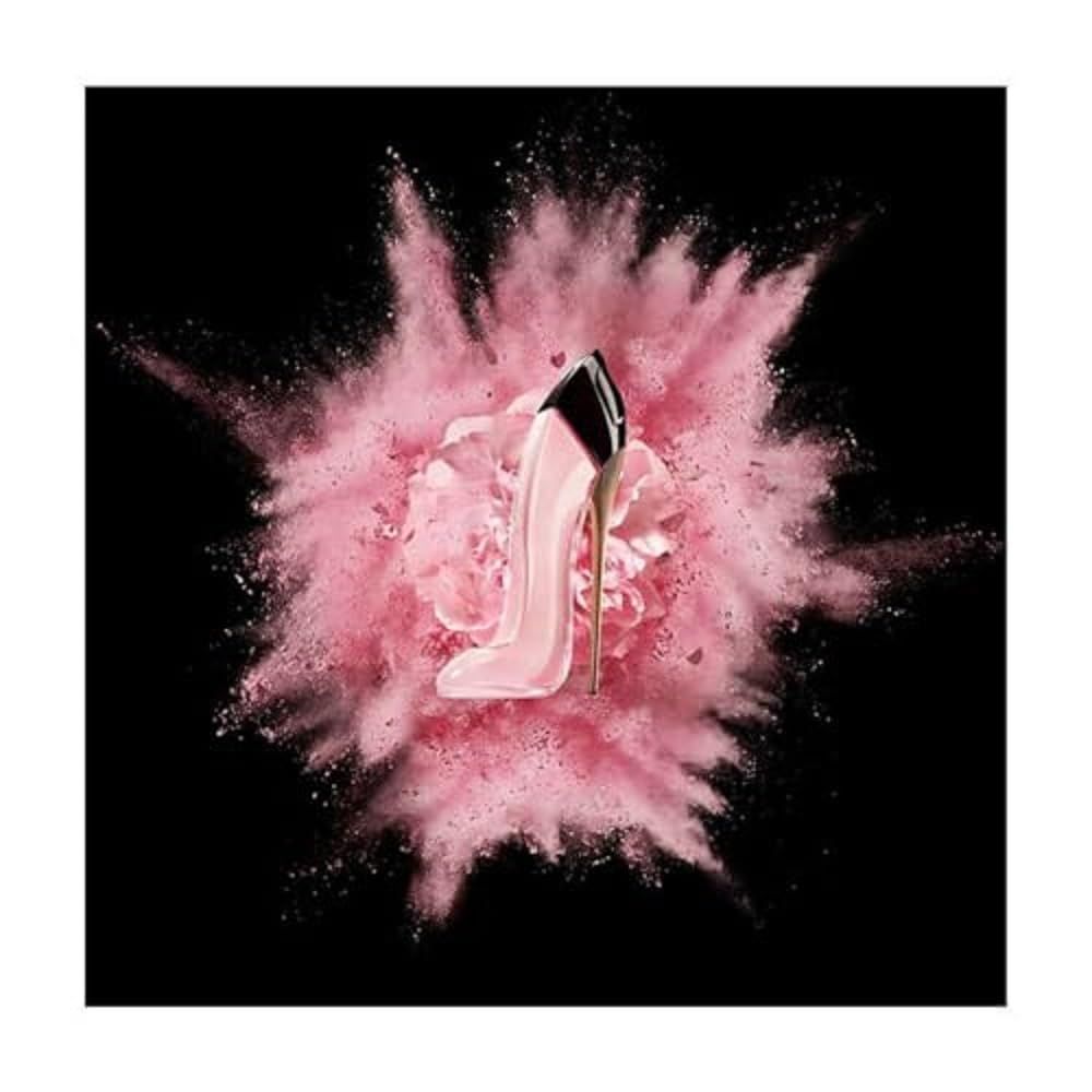Rosa High Heel-Parfümflakon vor rosa Explosion auf schwarzem Hintergrund.