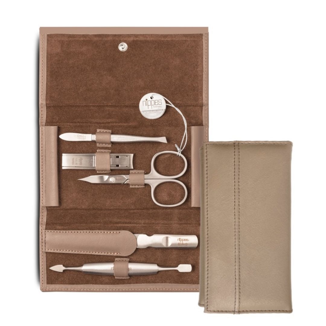 Maniküre-Etui DOVE, geöffnet. Enthält Nagelschere, Nagelfeile, Nagelknipser und weitere Werkzeuge. Beige Lederoptik.