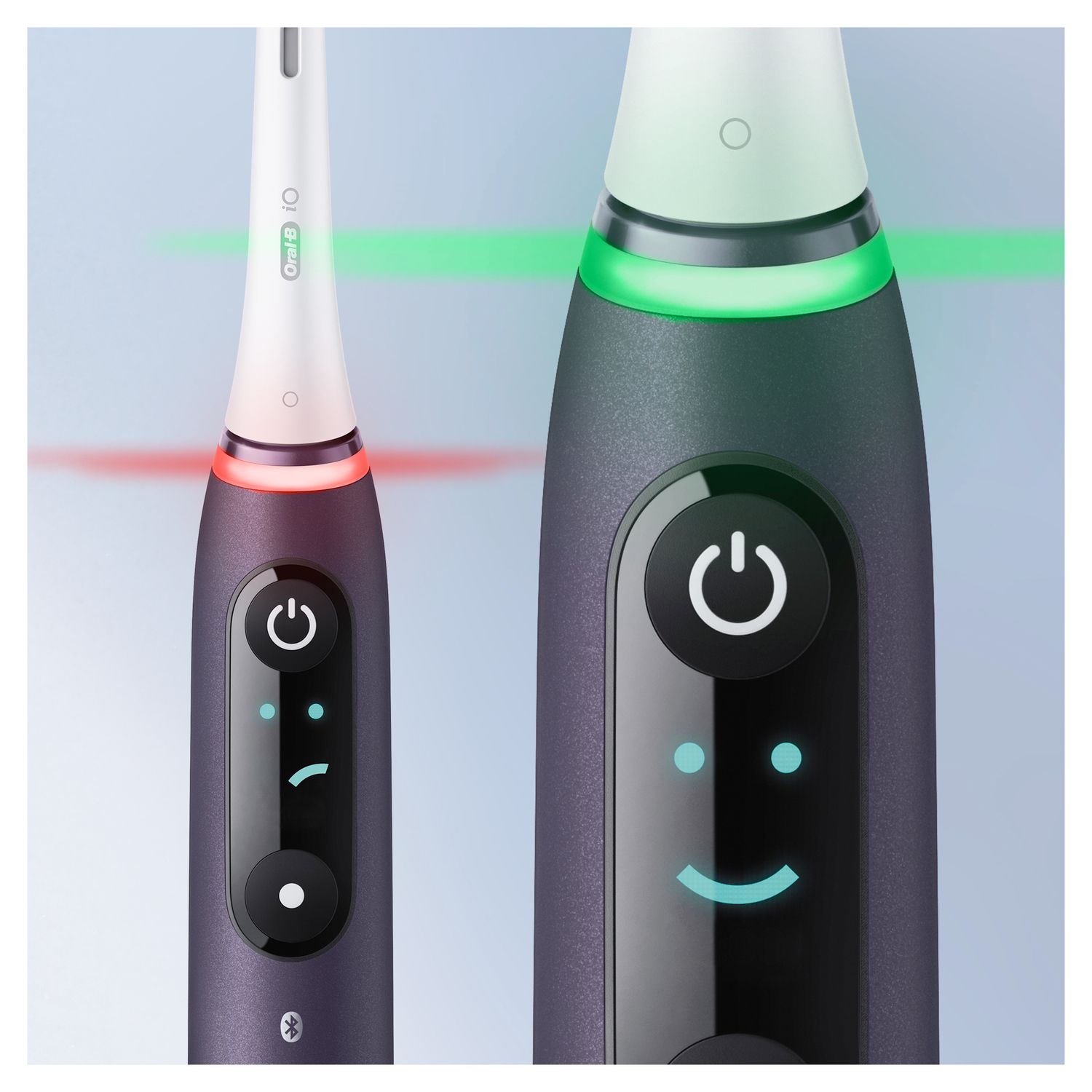 Zwei elektrische Zahnbürsten, violett. Auf dem Display wird ein Smiley und ein rotes/grünes Licht angezeigt.