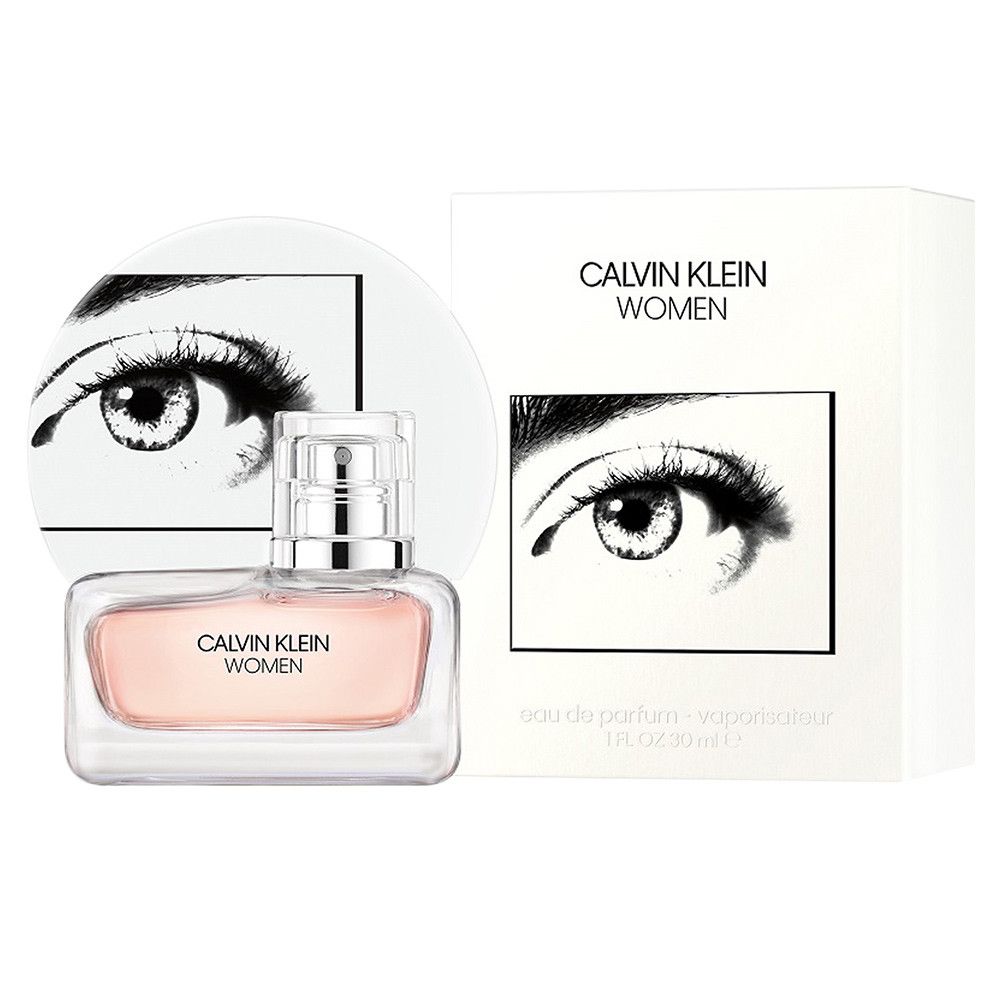 Flakon und Verpackung. Aufdruck: CALVIN KLEIN WOMEN. Verpackung weiß, mit Auge-Grafik. Flakon mit rosa Flüssigkeit.