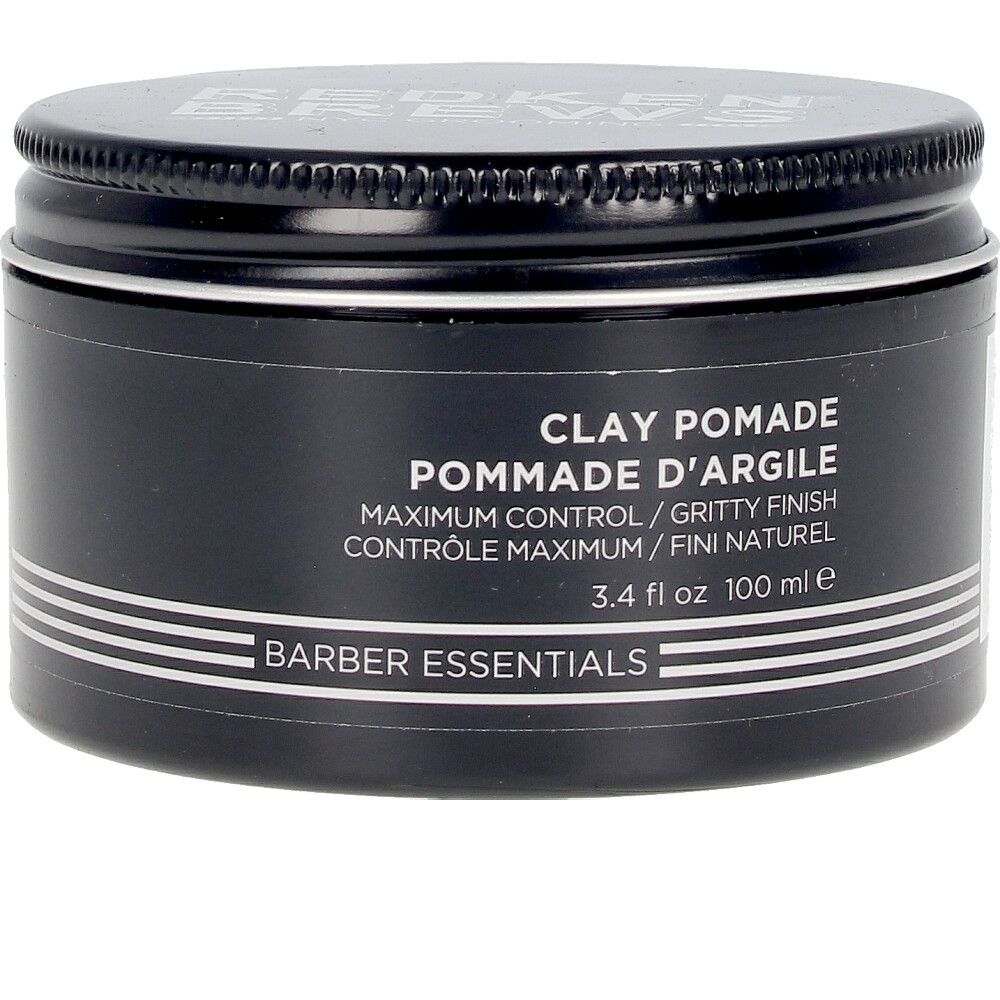 Schwarze Dose mit Deckel. Aufschrift: Clay Pomade, Pommade d'Argile, Barber Essentials. 3.4 fl oz 100 ml.