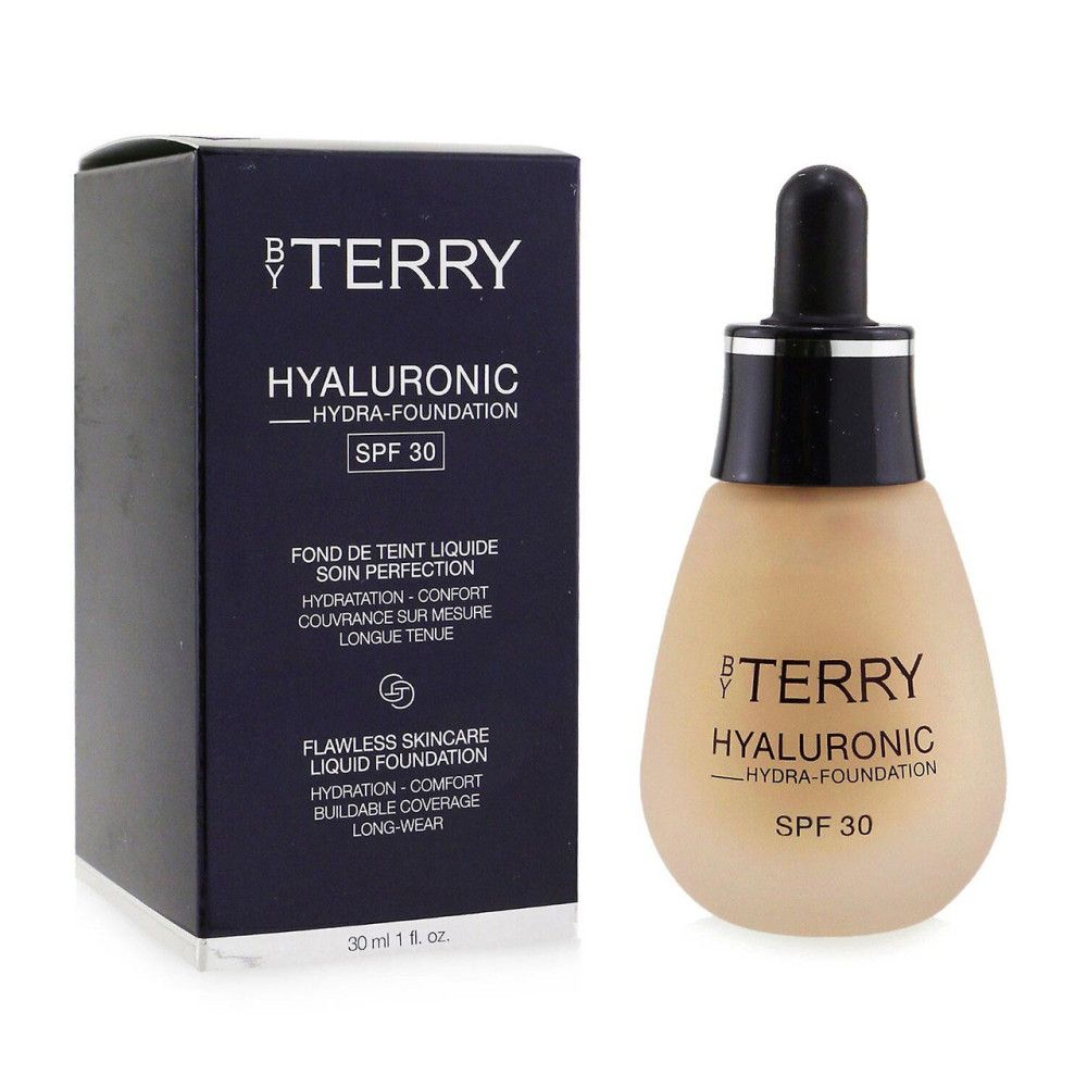 Foundation-Flasche und Schachtel. Flasche: By Terry, Hyaluronic Hydra-Foundation, SPF 30. Schachtel: Text, Flawless Skincare Liquid Foundation.