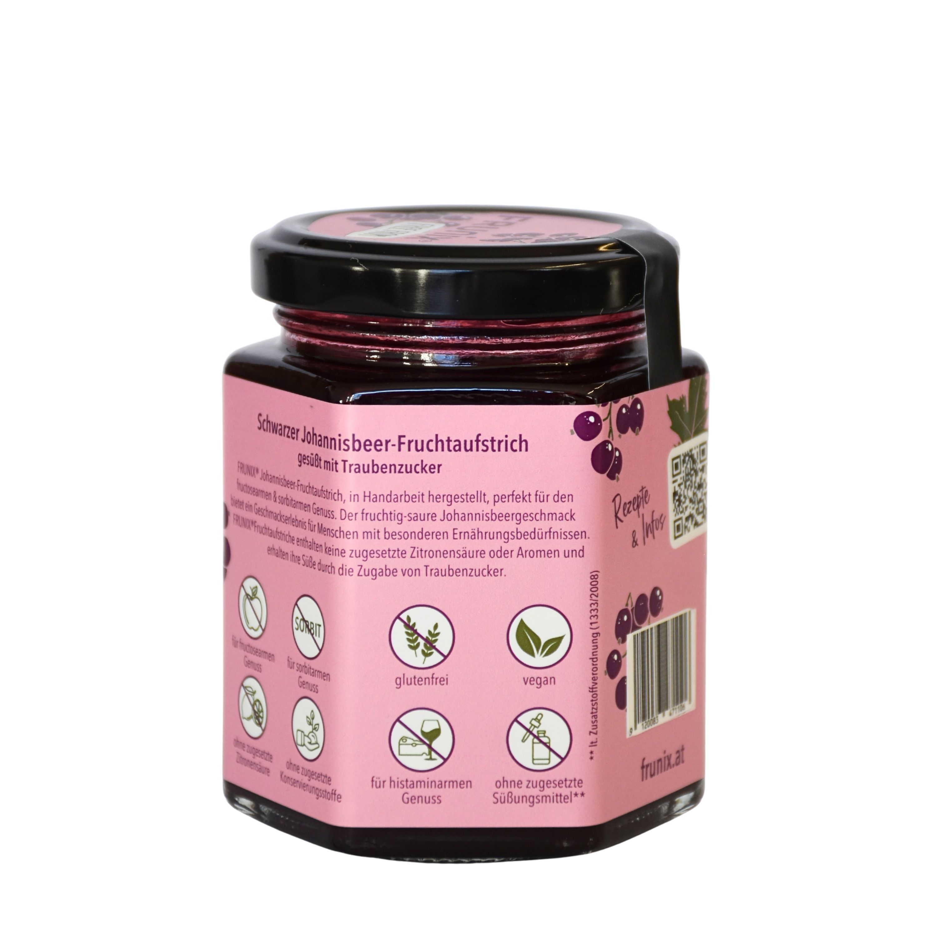 Glas mit schwarzem Johannisbeer-Fruchtaufstrich. Rosa Etikett mit Produktinformationen und Symbolen. Schwarzer Deckel.