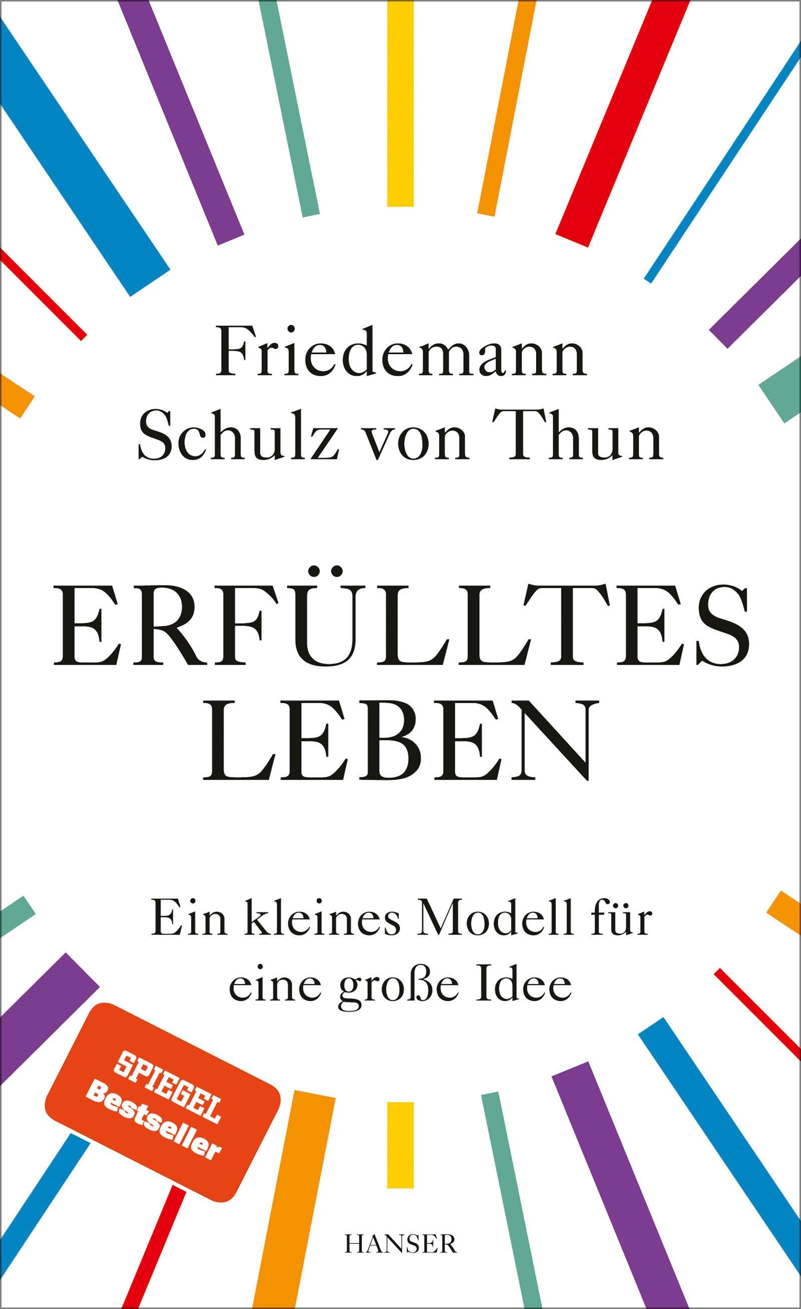 Buchcover von "Erfülltes Leben". Titel und Autor in Schwarz auf weißem Hintergrund. Bunte Strahlen umgeben den Titel. Spiegel Bestseller.