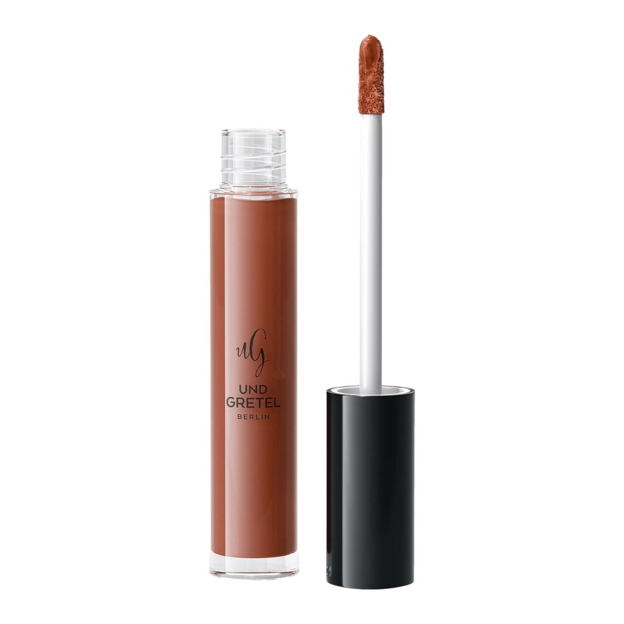 Flüssiger Lippenstift in einer Glasflasche mit schwarzem Deckel. Der Applikator ist herausgezogen. Auf der Flasche steht "Und Gretel Berlin".
