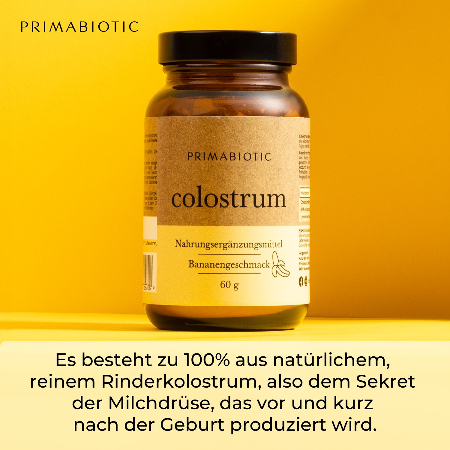 Braune Glasflasche mit schwarzem Deckel. Produktname, Bananengeschmack und 60g. Text: Besteht zu 100% aus natürlichem Rinderkolostrum.