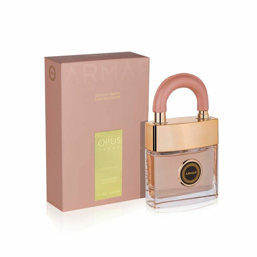 Parfümflakon mit rosa Griff und goldfarbenen Elementen, neben einer rosa Verpackung mit Text.