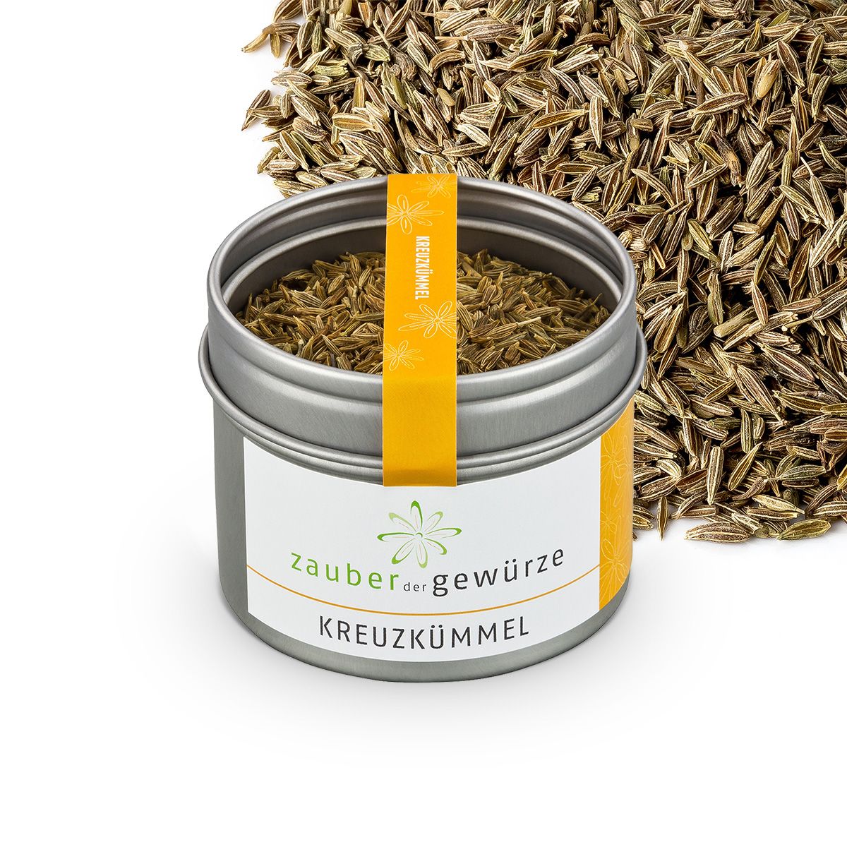 Metallbehälter mit Kreuzkümmel, daneben verstreute Samen. Etikett mit Produktname und Logo. Gelber Streifen.