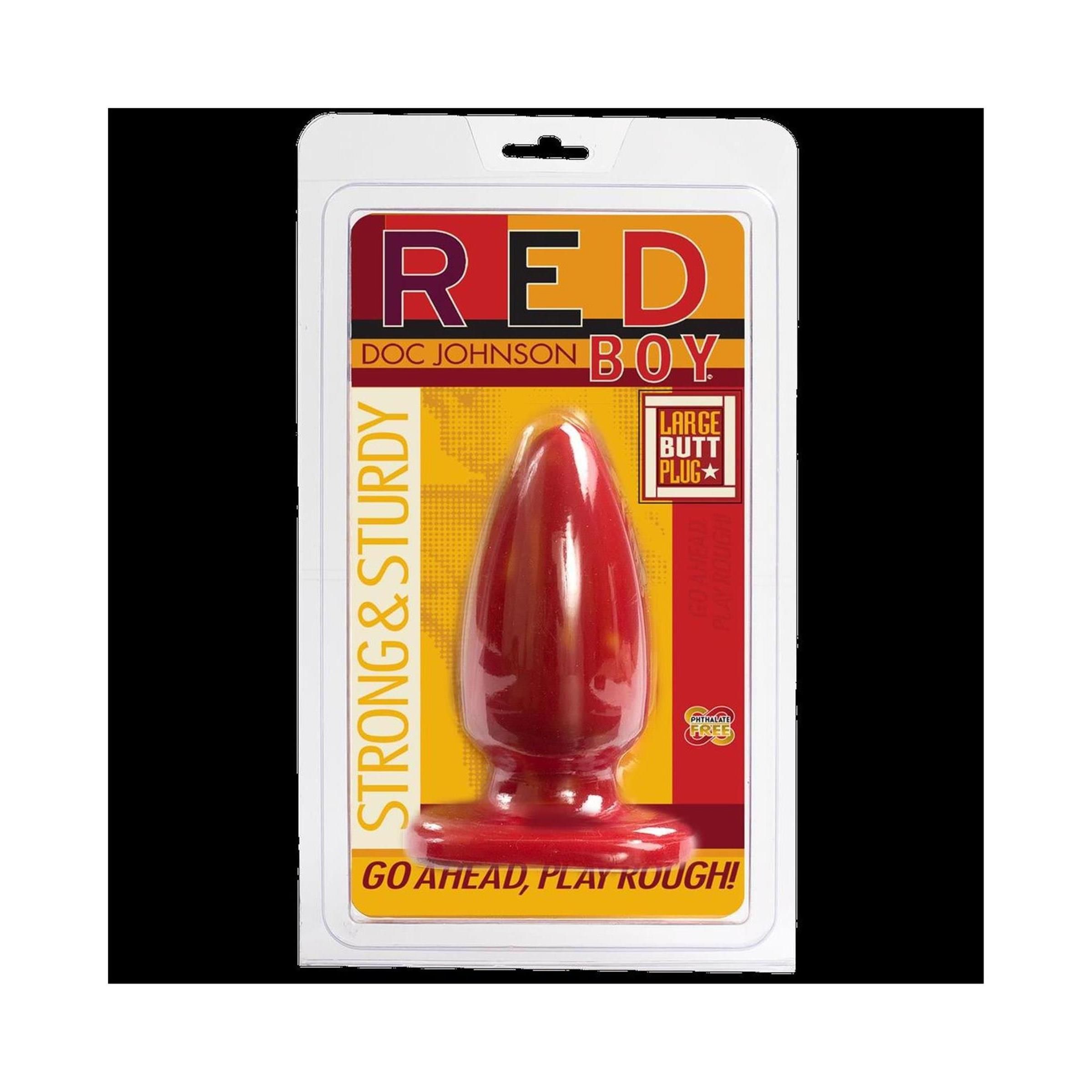 Roter Butt Plug in Verpackung. Aufschrift "RED BOY" und "DOC JOHNSON". "LARGE BUTT PLUG" und "STRONG & STURDY" sind ebenfalls zu sehen.
