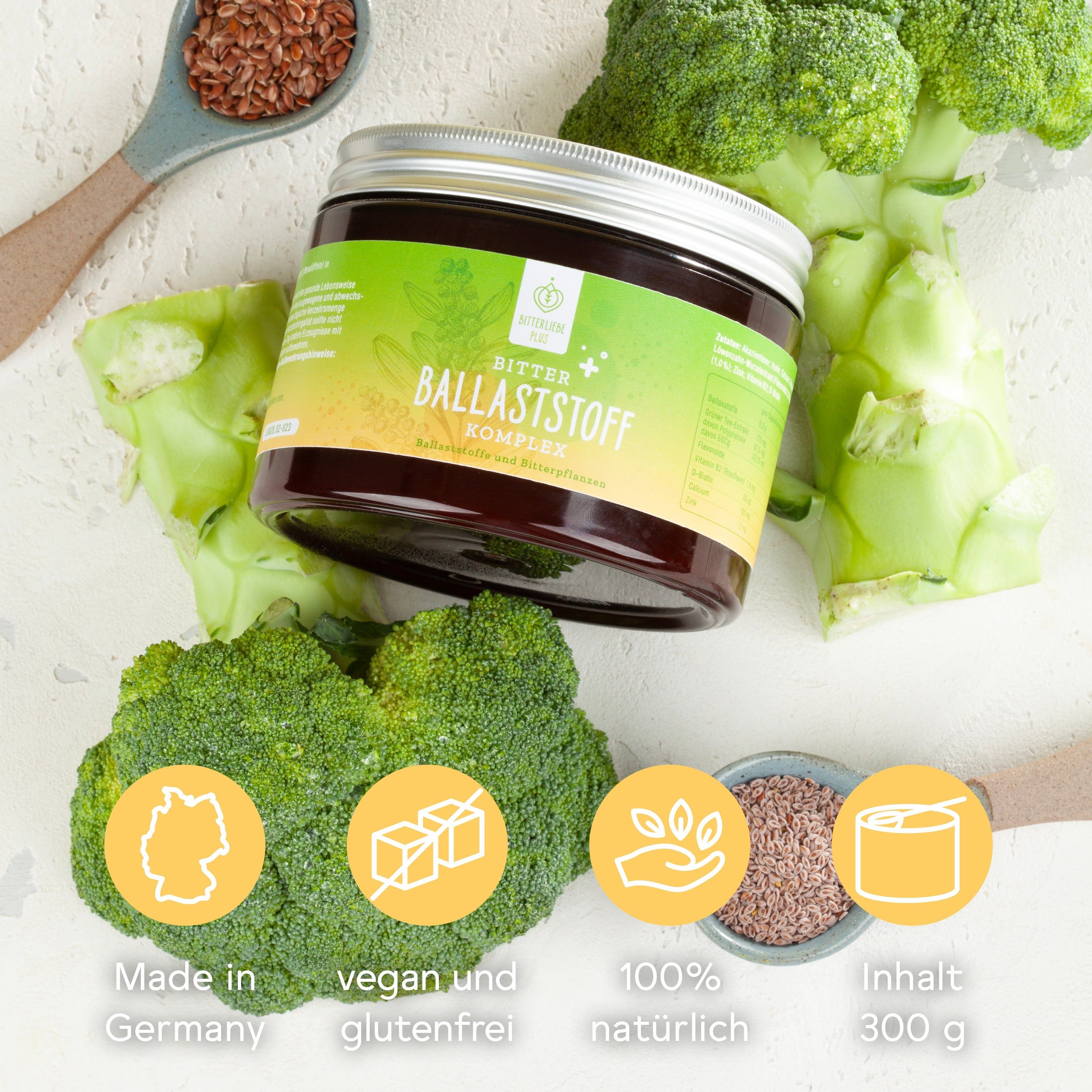 Dose mit gelb-grünem Etikett, Text: BitterLiebe Ballaststoff Komplex. Umgeben von Gemüse und Leinsamen. Icons.