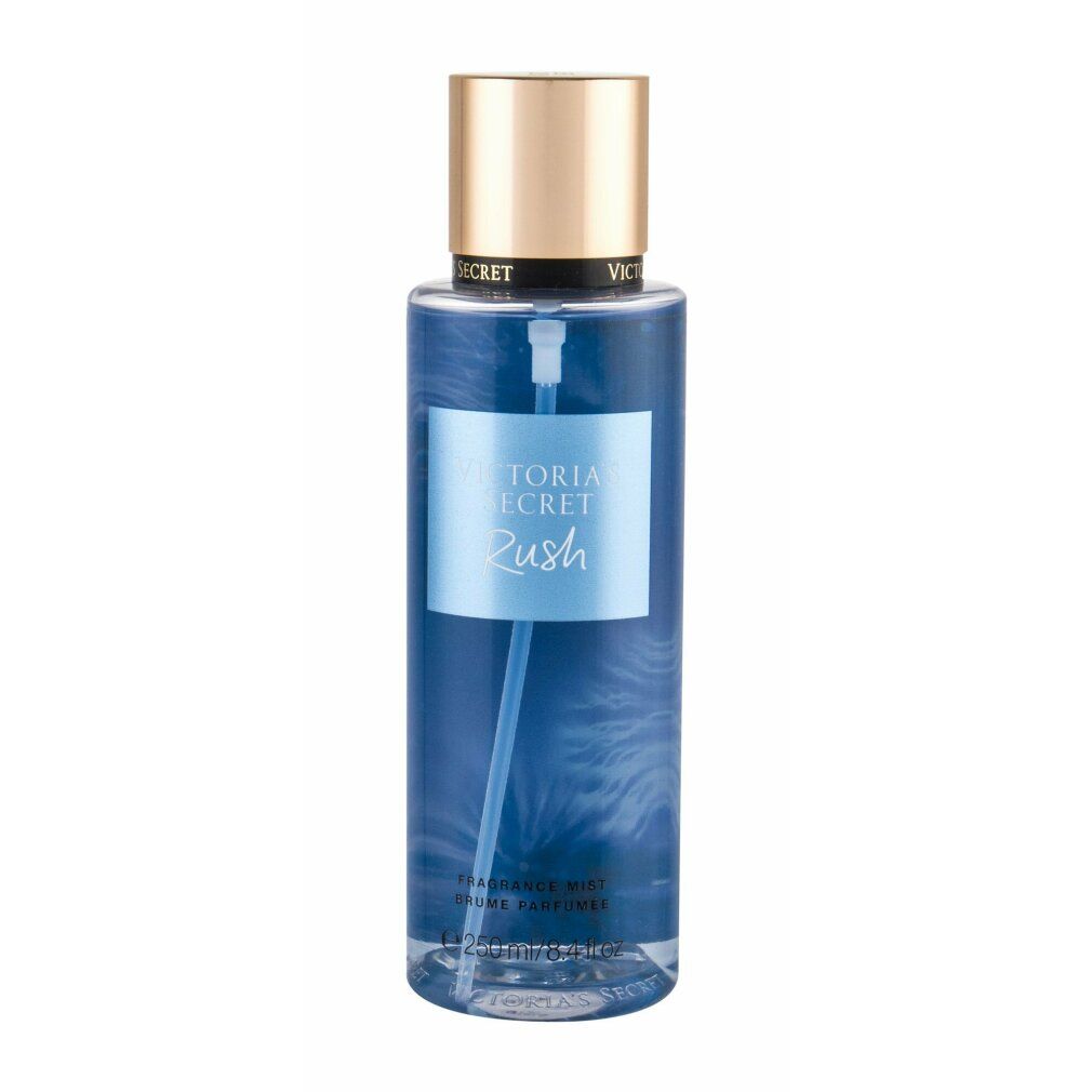 Victoria's Secret Rush Fragrance Mist. Blaue Flüssigkeit in einer zylindrischen Flasche. Goldfarbener Deckel. Produktname auf Etikett.